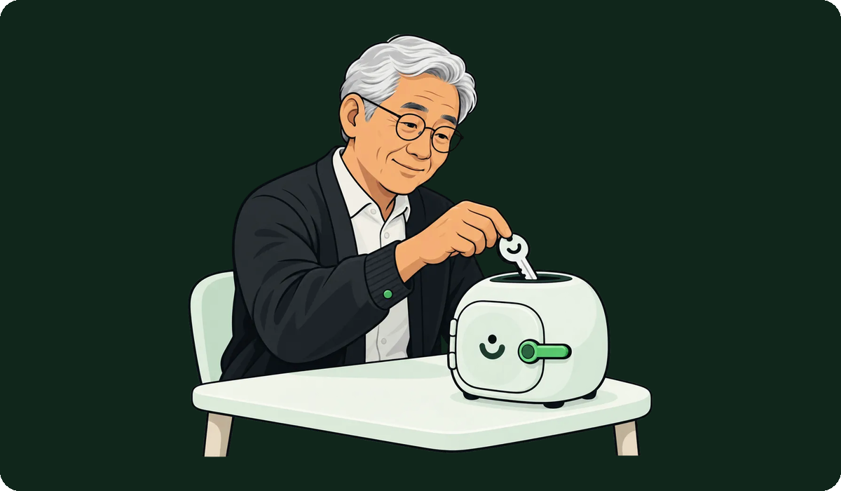 A man drops a key into a small, smiling vault on his desk.